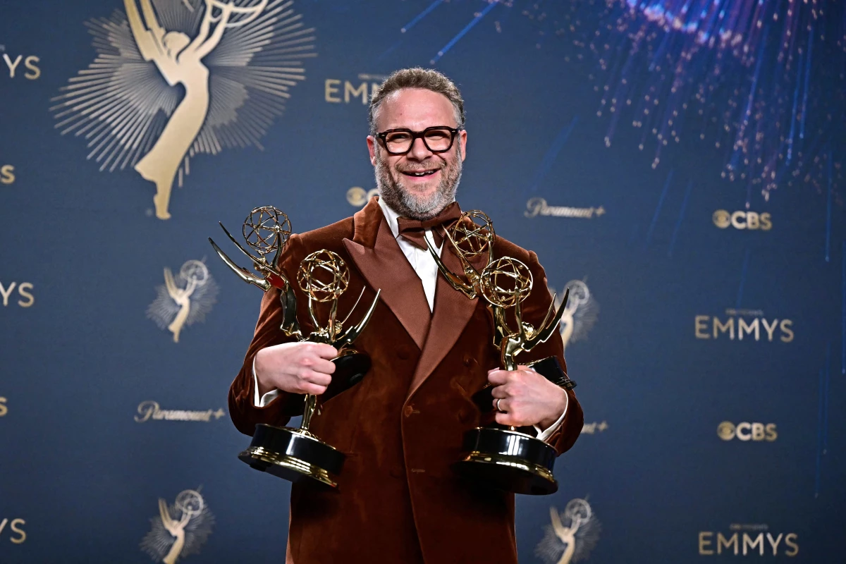 Seth Rogen poses with Emmys awarded to his comedy The Studio on Sunday night.
