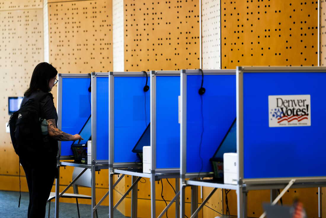 A voter casts her ballot in Colorado's primary election at the Central Library on June 30 in Denver.