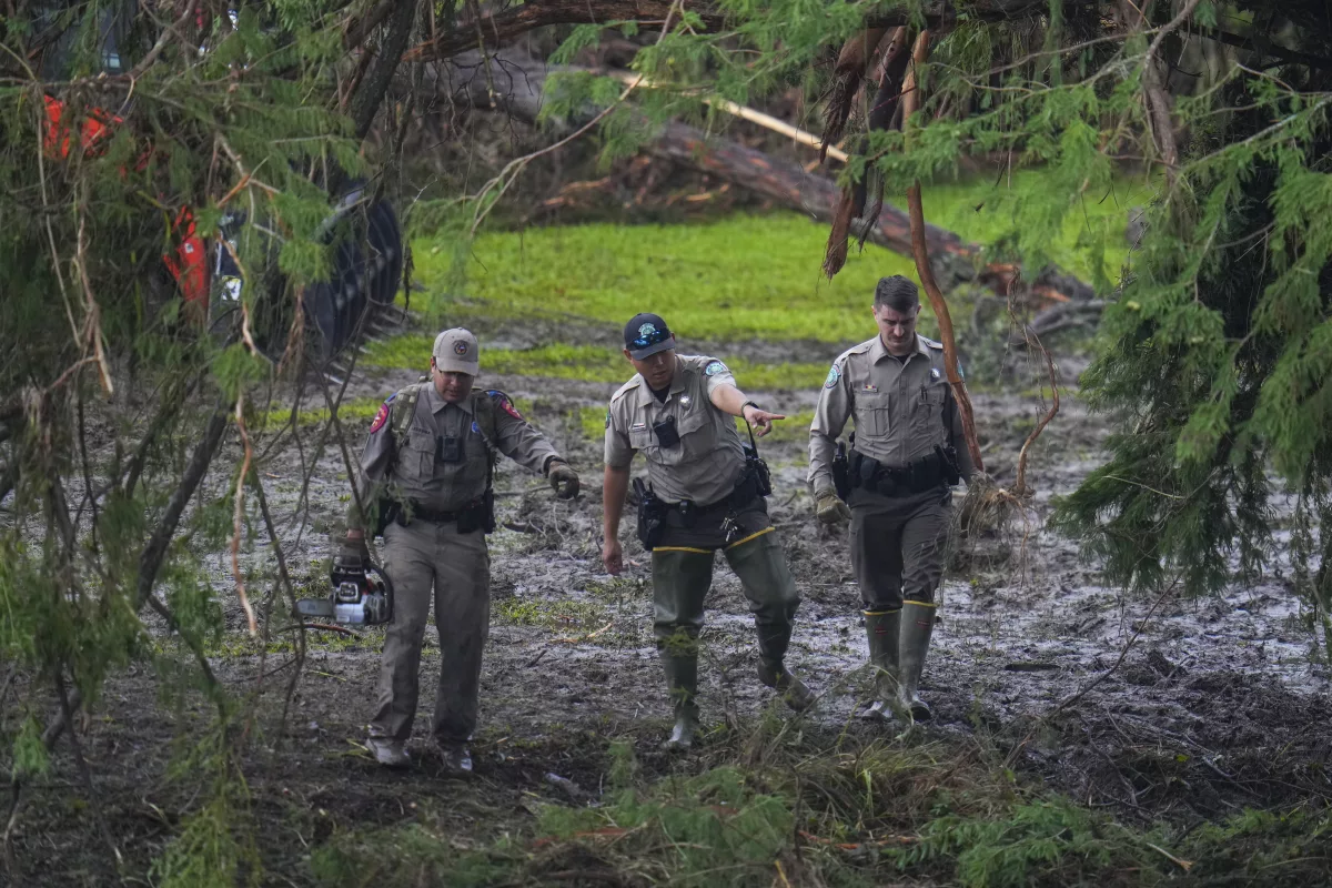 Officials inspect an area at Camp Mystic along the banks of the Guadalupe River after a flash flood swept through the area in Hunt, Texas.