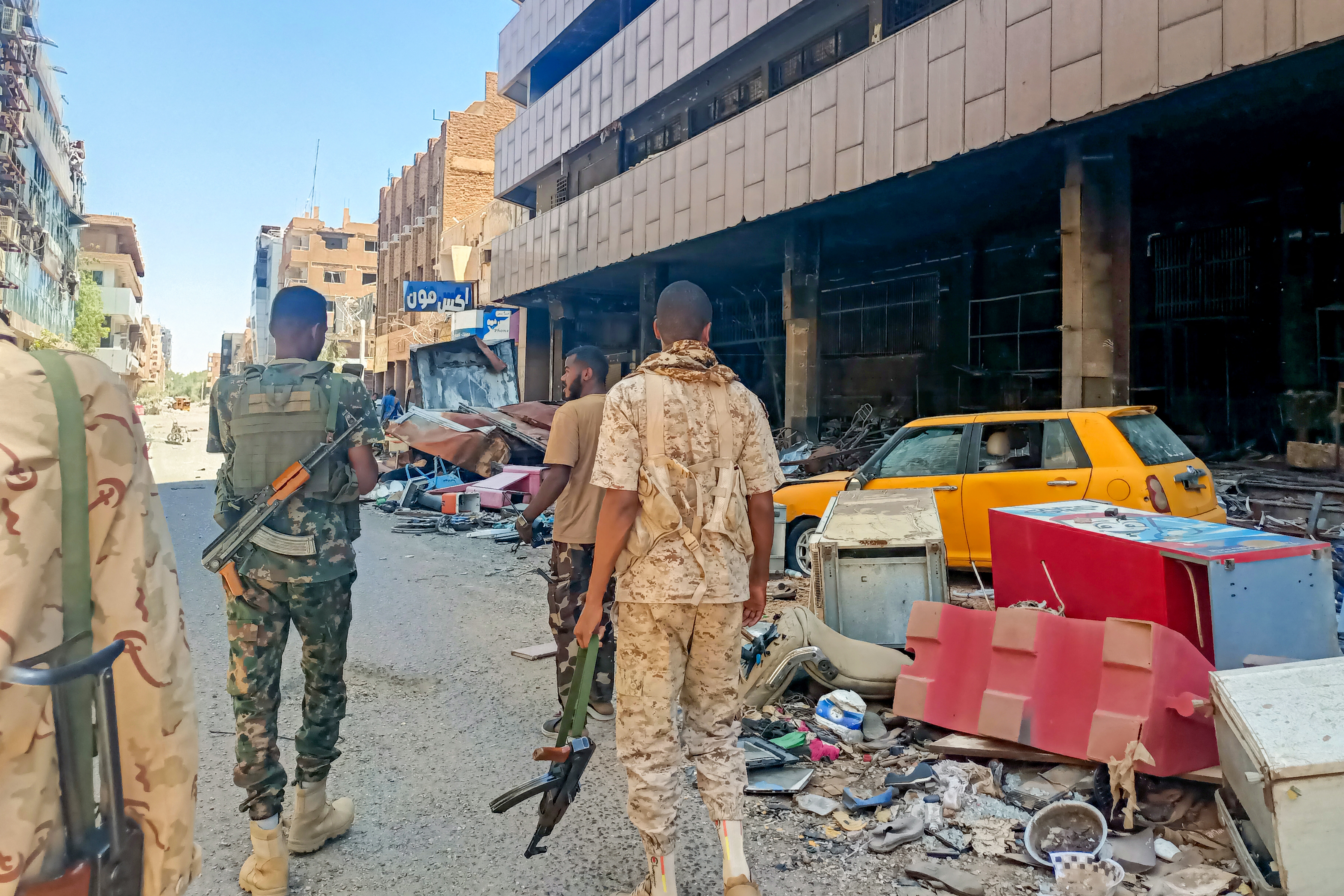 Army soldiers patrol a market area in Khartoum.