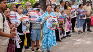 Relatives of recent flash flood victims hold banners urging authorities to step up efforts to find their missing loved ones during a demonstration in Kathmandu, Nepal, on Monday.