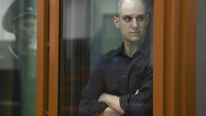 Wall Street Journal reporter Evan Gershkovich stands in a glass cage in a courtroom in Yekaterinburg, Russia, Wednesday. Fifteen months after he was arrested in the city of Yekaterinburg on espionage charges, Gershkovich returns there for his trial starting Wednesday behind closed doors.