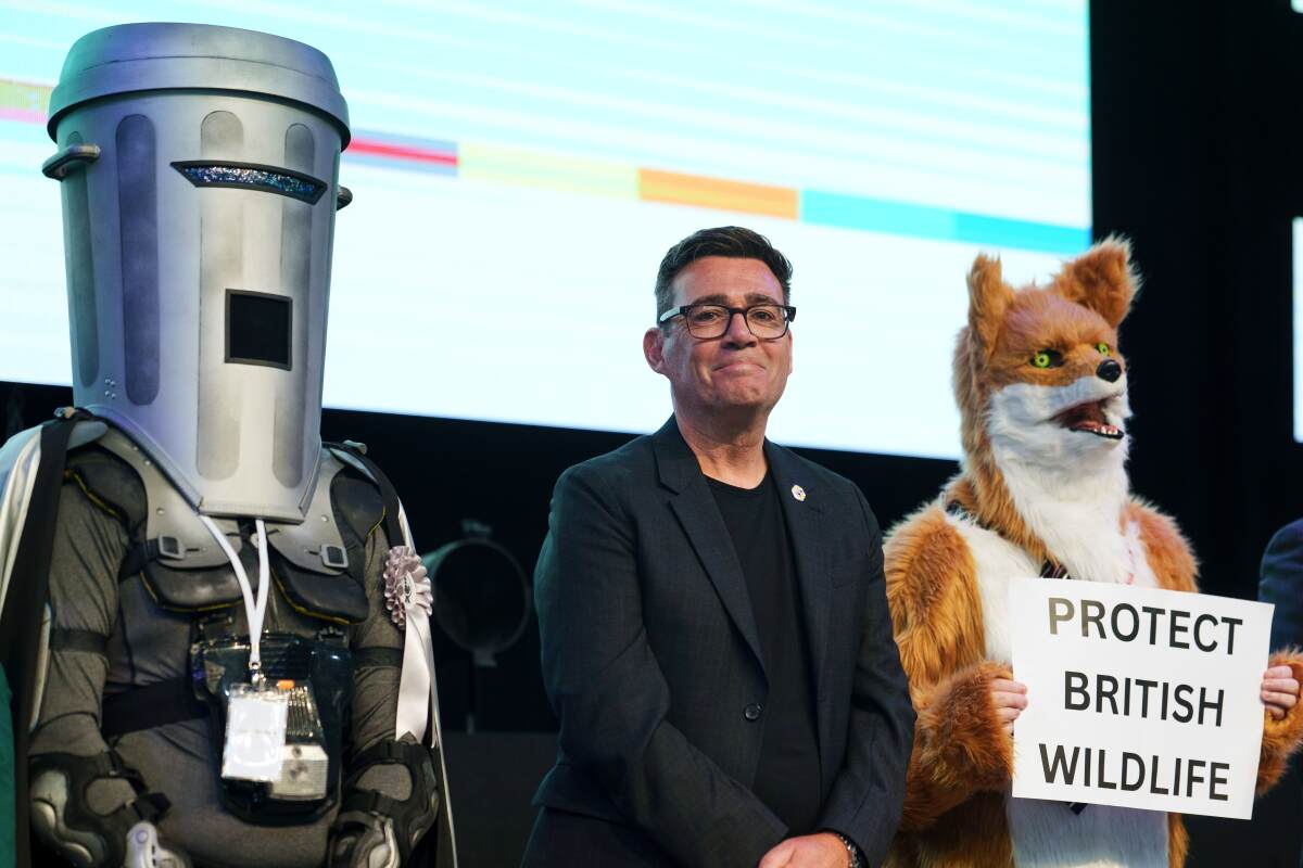 Labour's Andy Burnham stands with Count Binface and a Protect British Wildlife candidate after winning the Makerfield by-election, boosting his bid to become the UK's next prime minister, June 19, 2026.