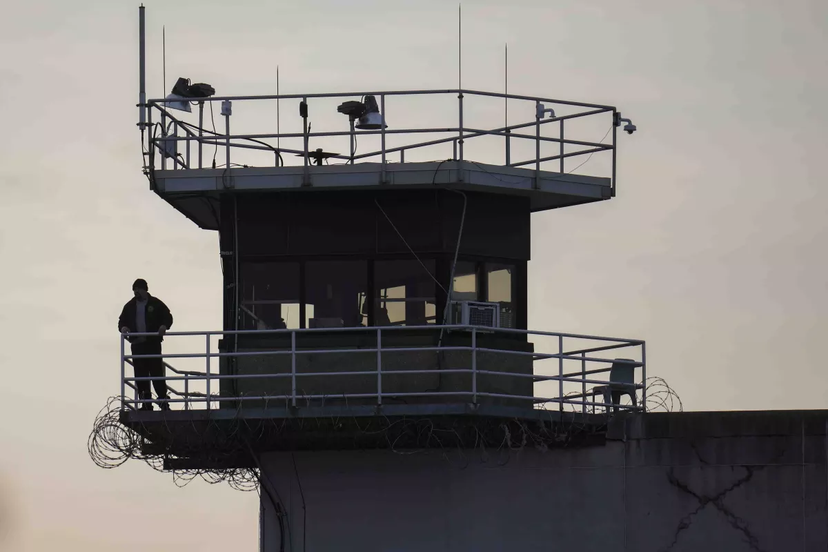 A guard stands in a tower at Indiana State Prison on Tuesday, Dec. 17, 2024, in Michigan City, Ind., where, barring last-minute court action or intervention by Gov. Eric Holcomb, Joseph Corcoran, 49, convicted in the 1997 killings of his brother and three other people, is scheduled to be put to death by lethal injection before sunrise on Wednesday.