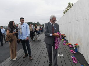 Visitors pay their respects at the Wall of Names shortly before a ceremony honoring those who died aboard Flight 93 on Sept. 11, 2001, at the Flight 93 National Memorial in Shanksville, Pa., on Friday.
