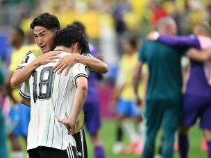 Teammates on Japan's national team react at the end of the World Cup match between Brazil and Japan in Houston on June 29. Brazil won 2-1.