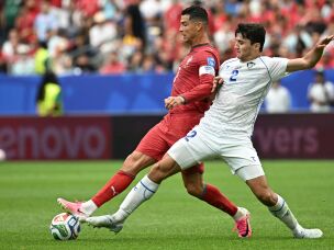 Portugal's Cristiano Ronaldo (left) fights for the ball with Uzbekistan's Abdukodir Khusanov during the World Cup match between Portugal and Uzbekistan in Houston on June 23. Last year, Khusanov became the first Uzbek player to compete in the Premier League.