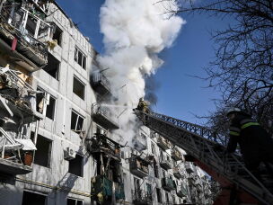 Firefighters put out a fire after a bombing of the eastern Ukrainian town of Chuhuiv on Feb. 24, 2022, as Russian armed forces invaded Ukraine.