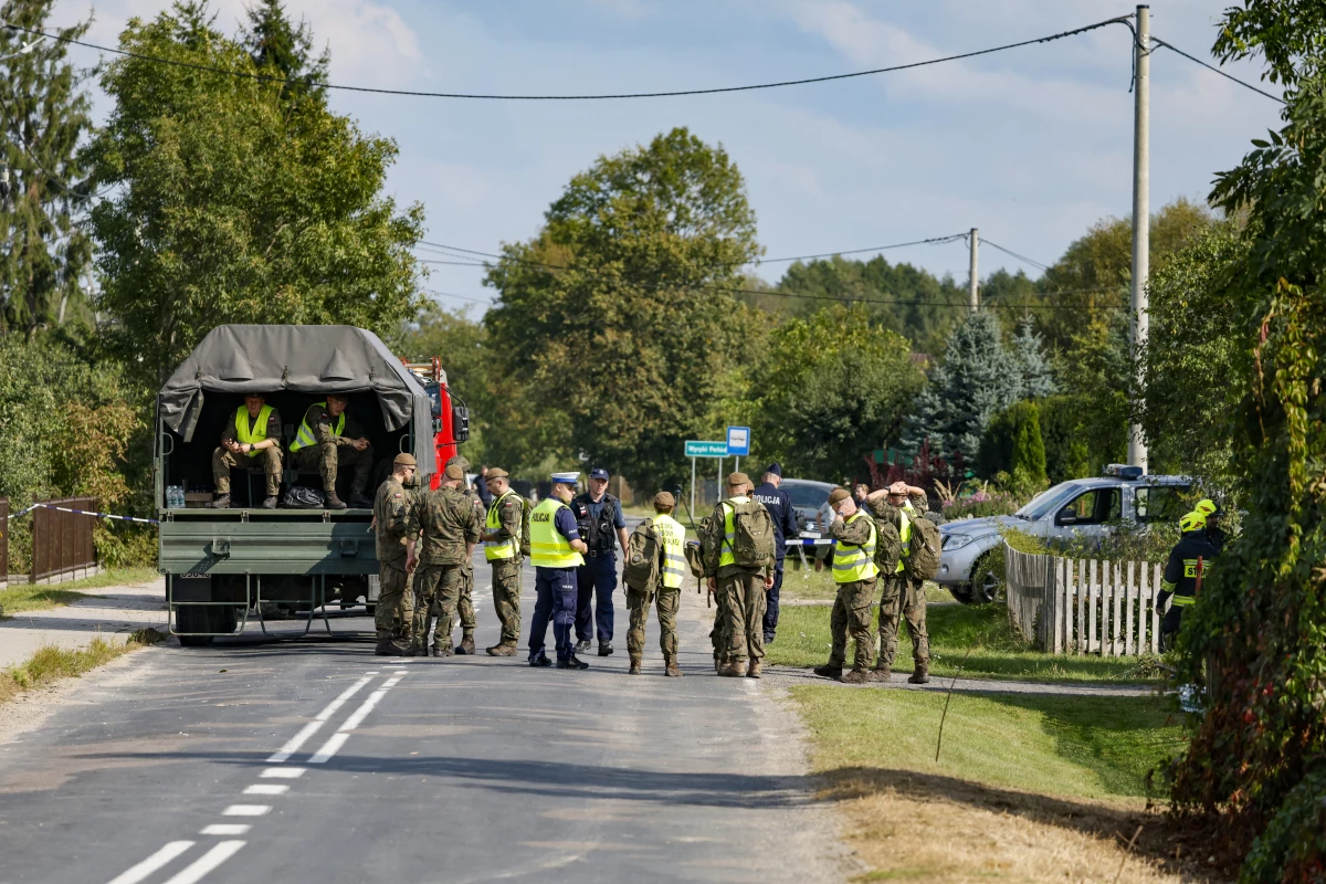 Police and army gather to inspect a house destroyed by debris from a shot down Russian drone in the village of Wyryki-Wola, eastern Poland, on September 10.