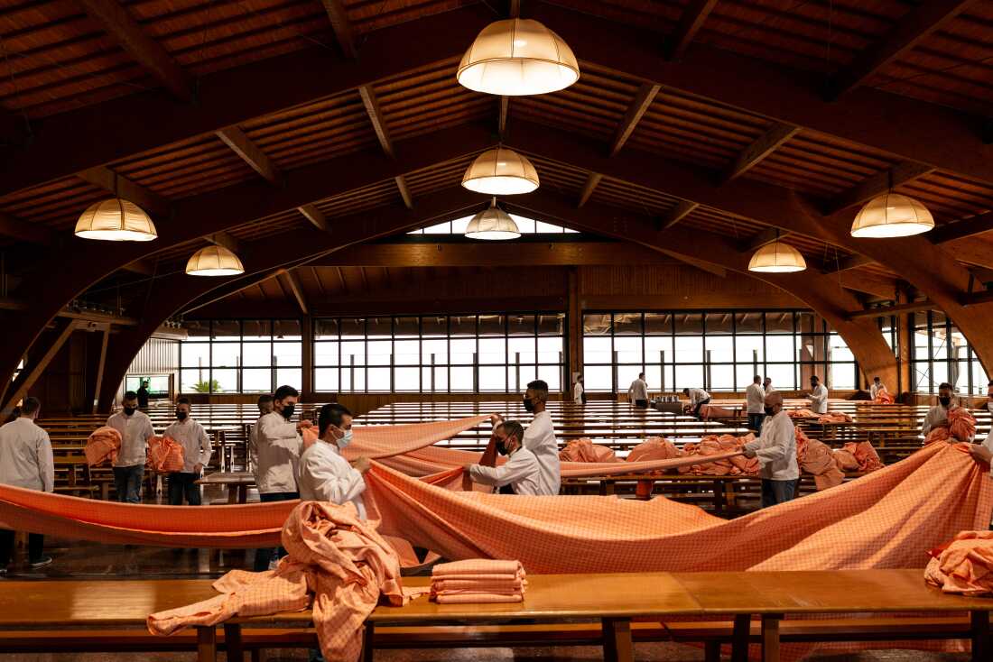Men in rehabilitation, in the lounge managing sector, set the tables for dinner at San Patrignano on March 8, 2021 in Coriano, Italy.