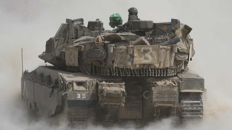 Israeli soldiers move tanks around staging area near the border with the Gaza Strip, in southern Israel, Sunday, May 18, 2025.