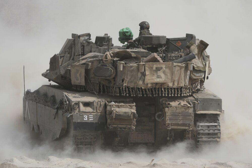 Israeli soldiers move tanks around staging area near the border with the Gaza Strip, in southern Israel, Sunday, May 18, 2025. (AP)