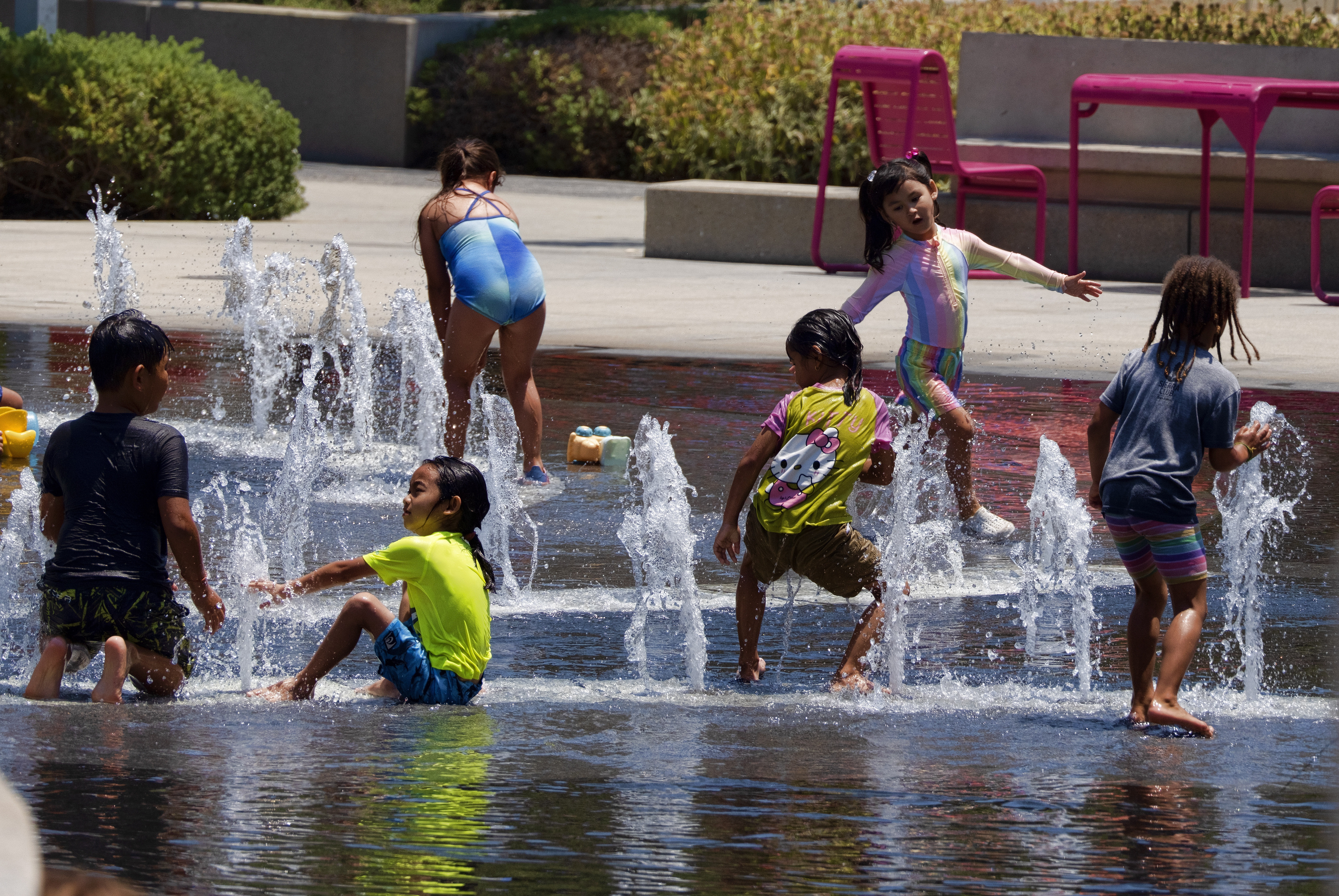 City kids attempt to cool off in a fountain in Grand Park in downtown Los Angeles on Sunday, July 16, 2023. (AP)