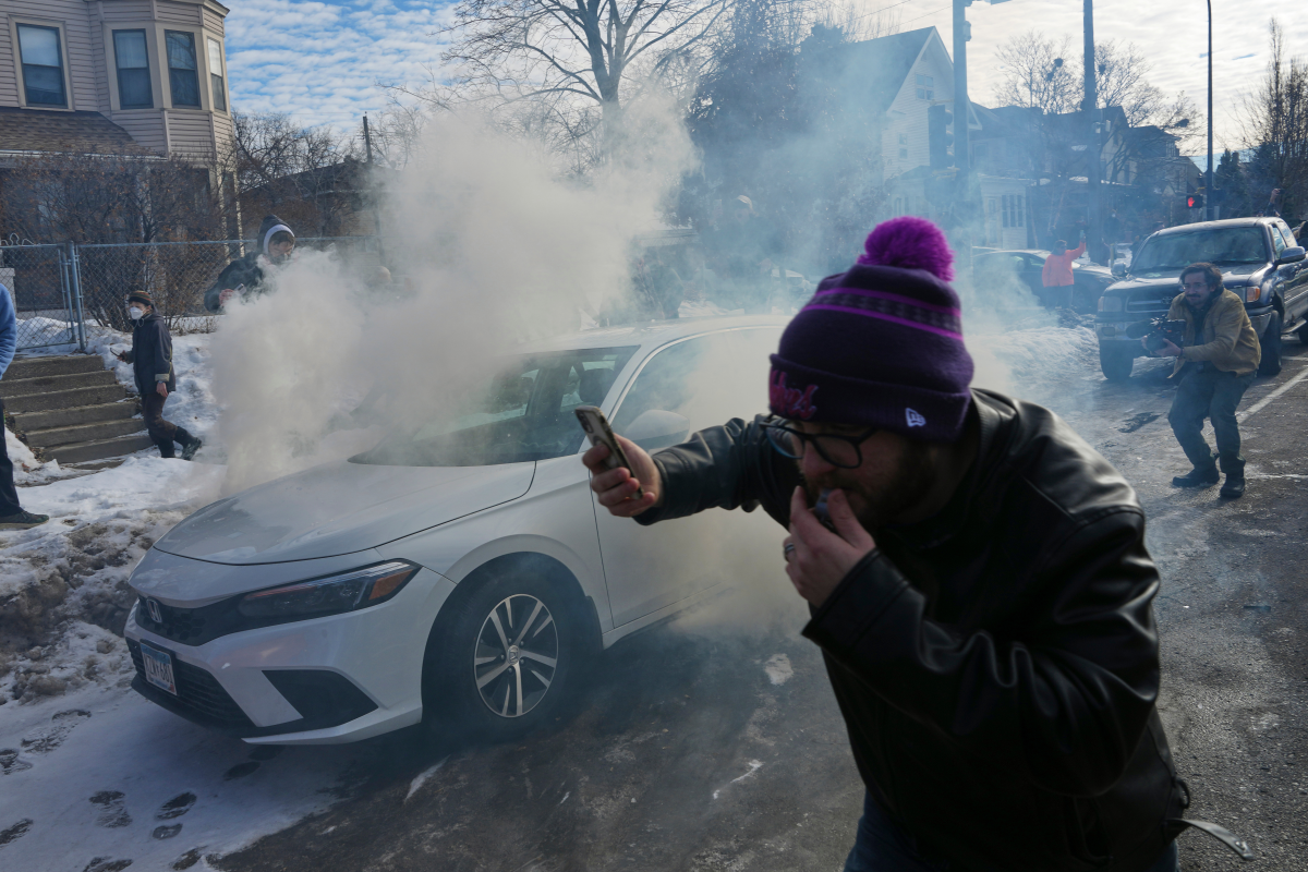 Protesters try to avoid tear gas dispersed by federal agents in Minneapolis on Jan. 12.