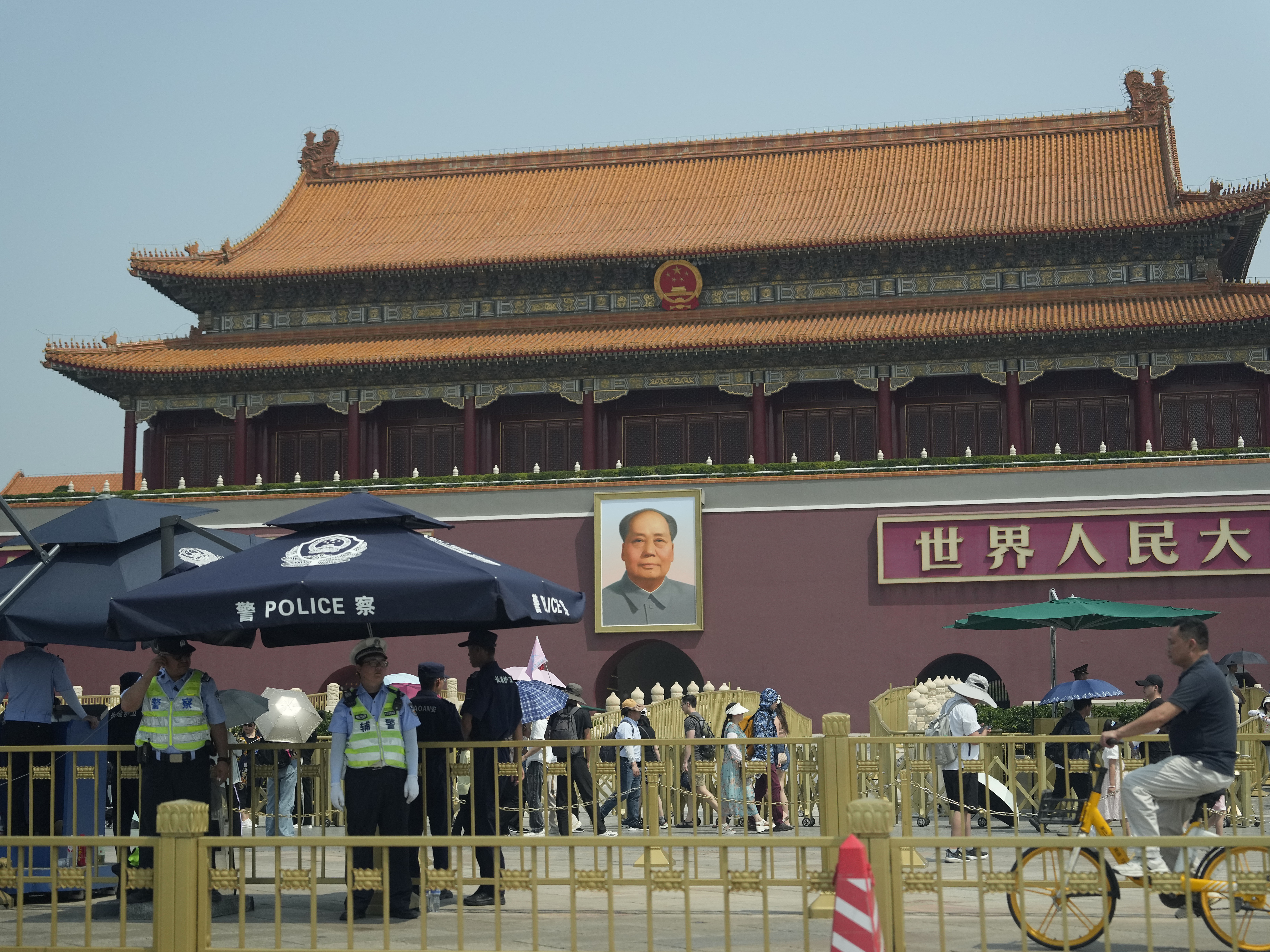 Police officers watch over Tiananmen Gate on Tuesday in Beijing. As Beijing