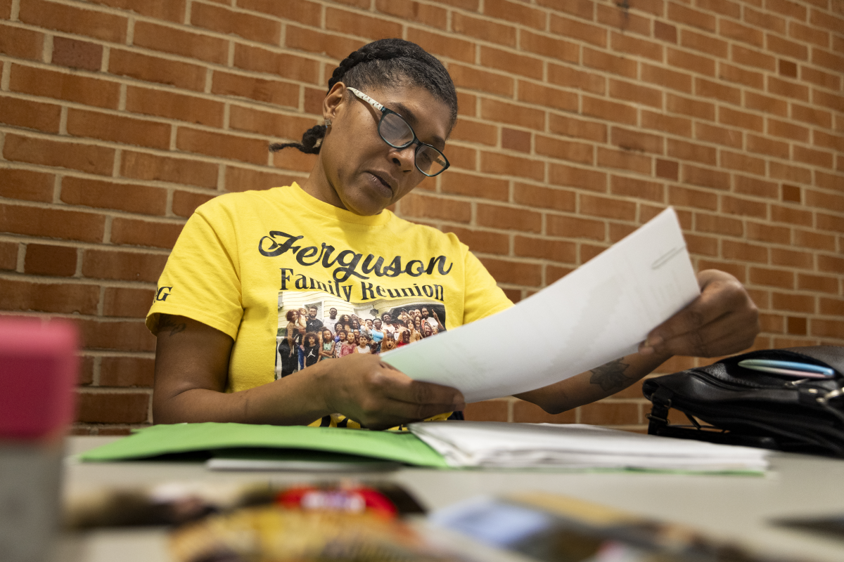Tyeesha Ferguson looks through police reports, court files, and hospital records for her son, Quincy Jackson III.
