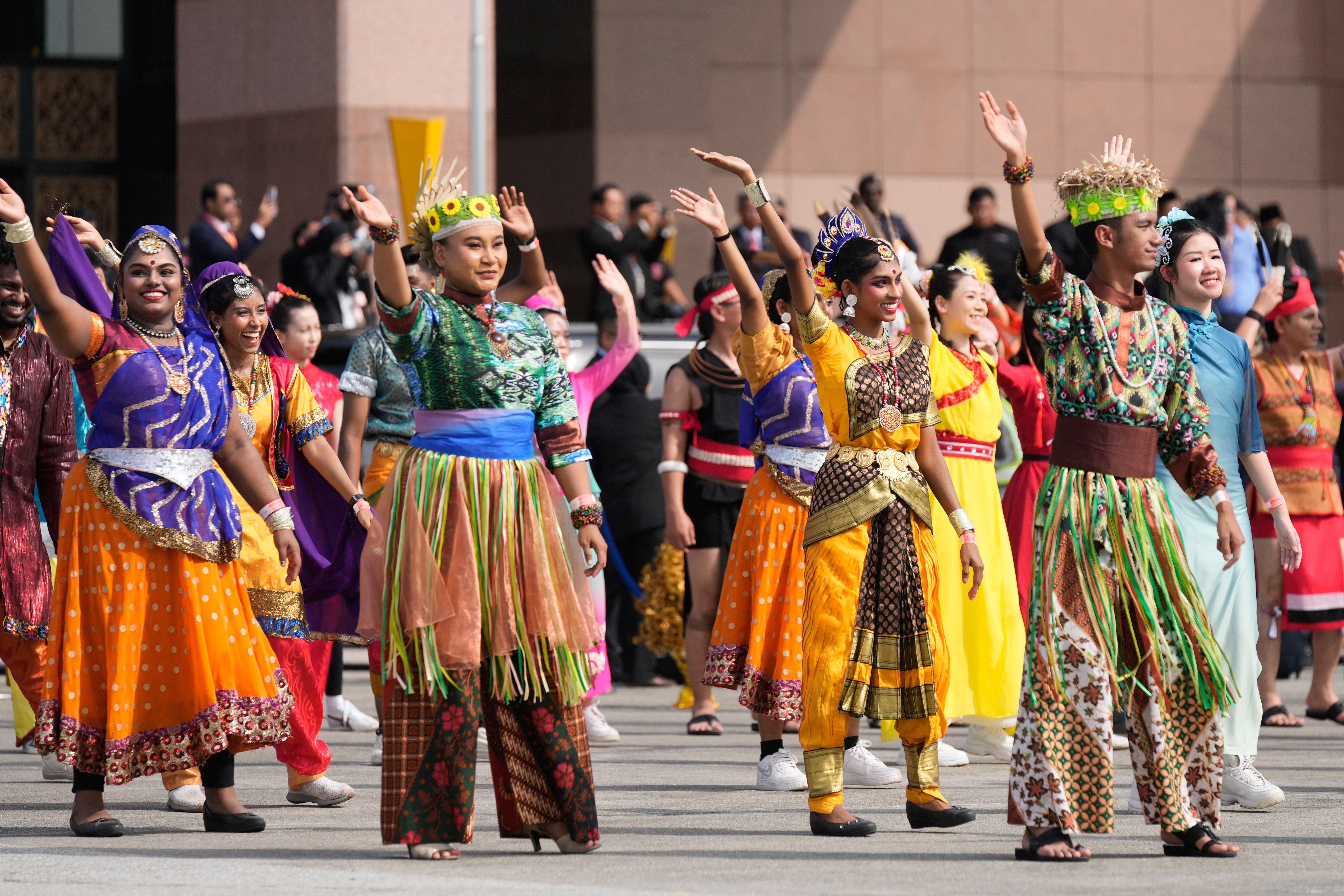 Dancers perform as President Donald Trump boards Air Force One at Kuala Lumpur International Airport in Sepang, Malaysia, as he departs for Japan, Monday, Oct. 27, 2025.