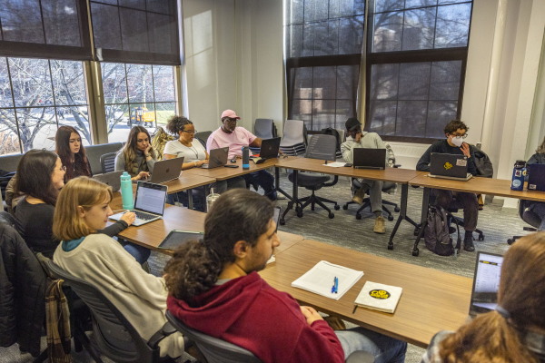 Dell Pippins and his cohorts listen during a class in North Hall at the University of Iowa in Iowa City on Wednesday, Dec. 6, 2023. Pippins is pursuing a doctorate in sociology in Iowa after obtaining a master’s degree in statistical science from the University of Idaho, studying remotely from prison.