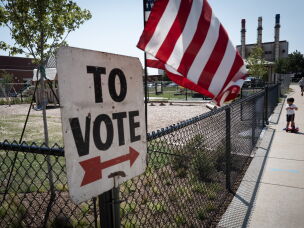 A sign directs residents to a polling place on Tuesday in Dearborn, Mich.