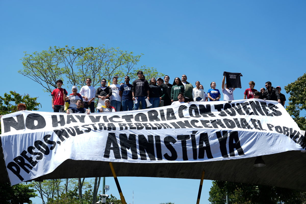 People attend a student-led march on National Youth Day to call for the release of detainees, considered to be political prisoners by their relatives and human rights groups, in Caracas, Venezuela, Thursday, Feb. 12, 2026.
