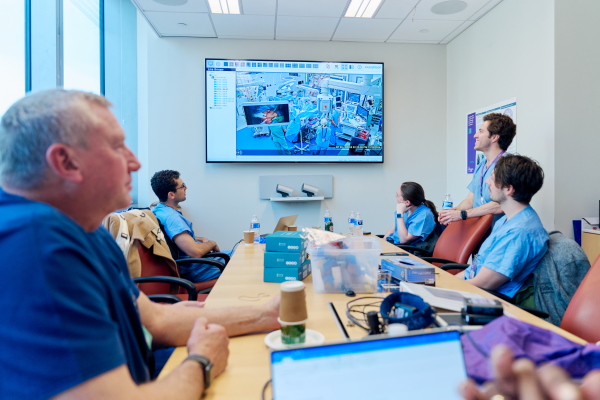David Ayers (foreground left), chief science officers at Revivicor, of Blacksburg, Va., watches a surgical team transplant a kidney from one of the company’s genetically modified cloned pigs into a patient.