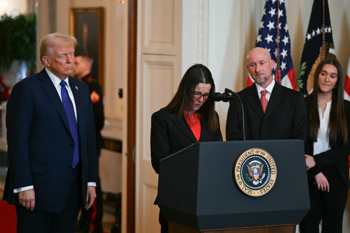 President Trump looks on as Allyson Phillips, mother of Laken Riley, speaks before Trump signed the Laken Riley Act in the East Room of the White House on Jan. 29.