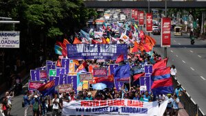 Protesters march during a rally by transport workers and activists protesting the rise in oil prices on Friday, March 27, 2026, near the Malacanang presidential palace in Manila, Philippines.