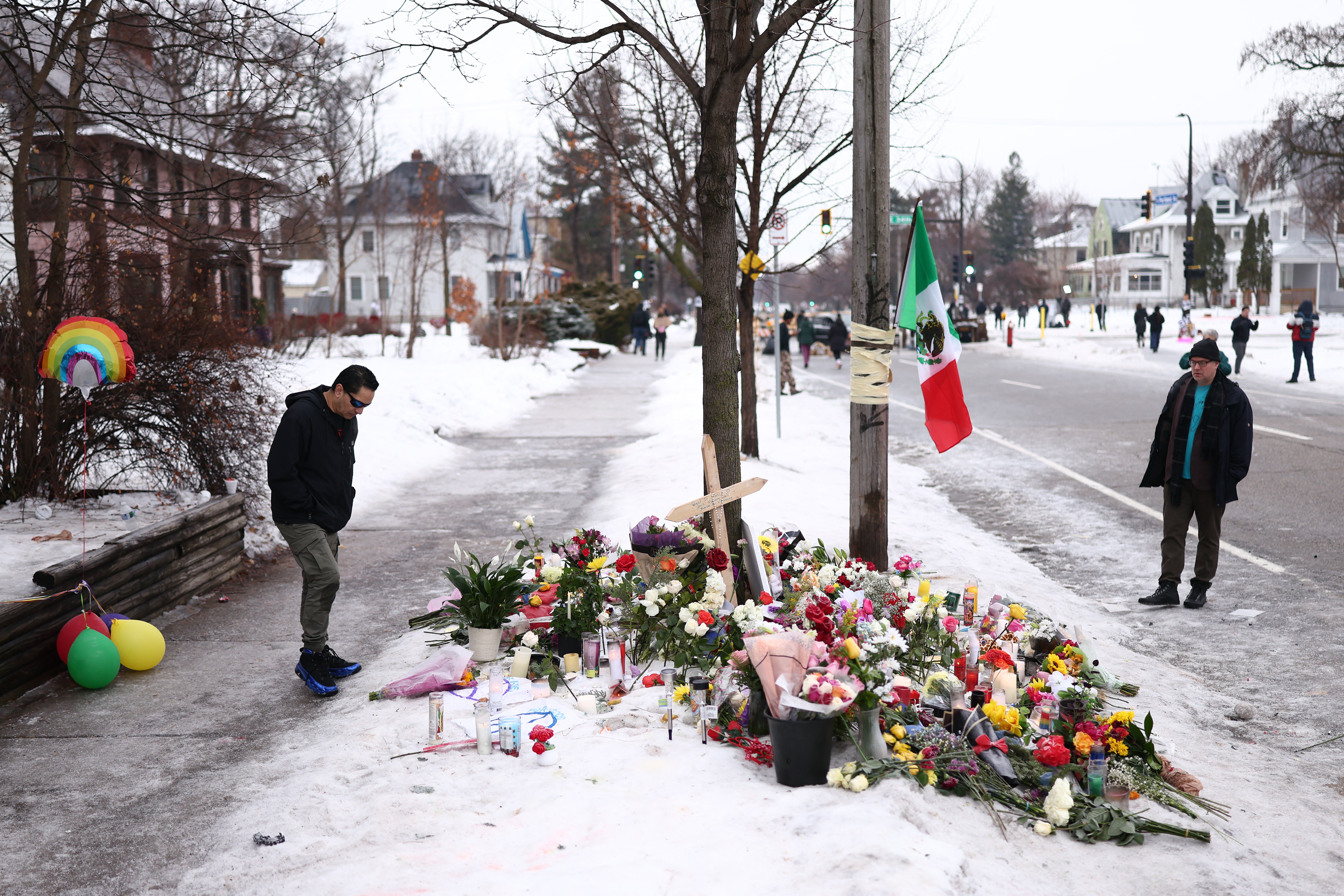 People gather at a makeshift memorial for Renee Nicole Good, 37, who was shot and killed on Wednesday by an ICE officer in Minneapolis. (AFP via Getty Images)