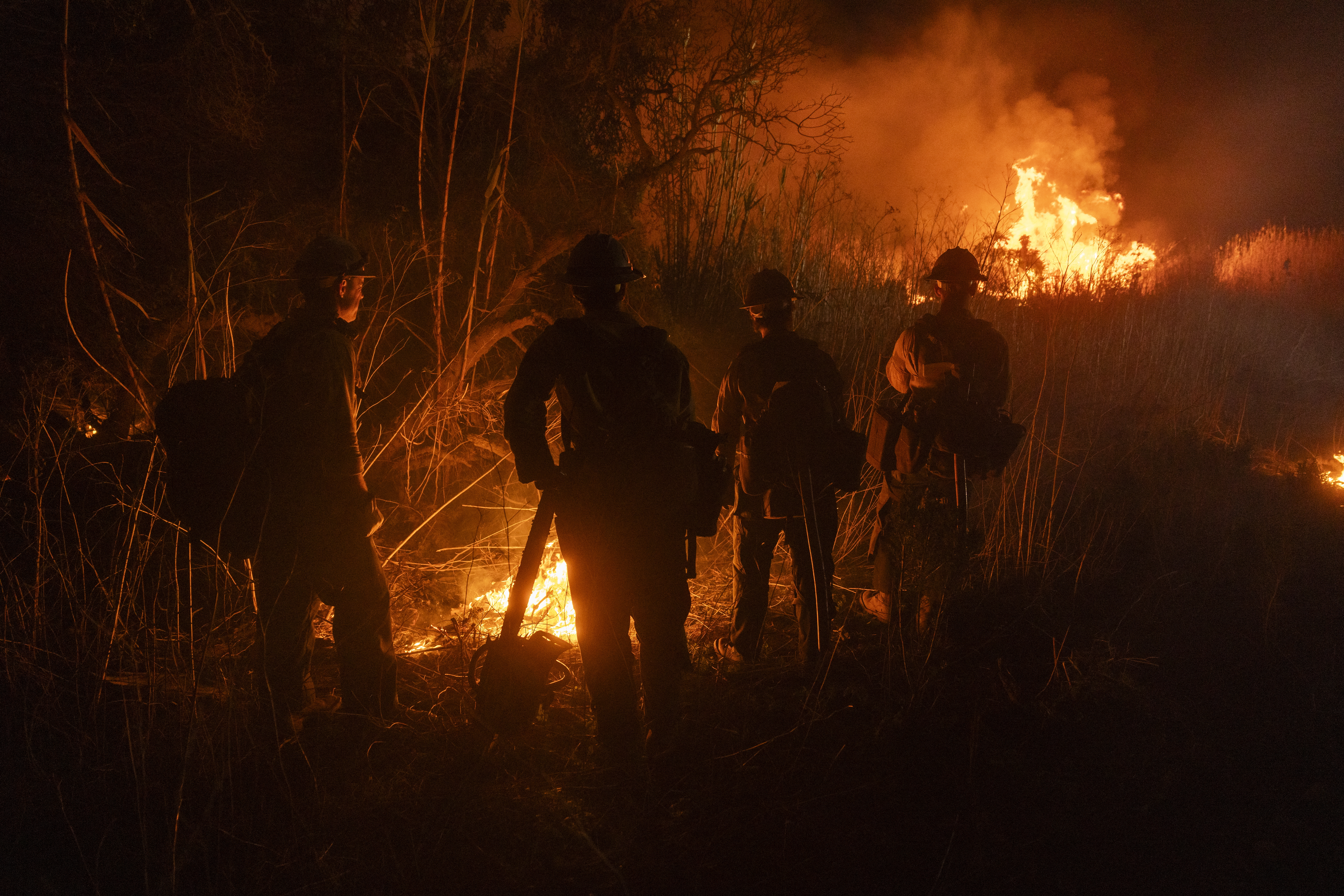 Firefighters monitor and control the spread of the Auto Fire in Oxnard, Calif., northwest of Los Angeles on Jan. 13, 2025.