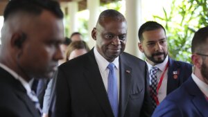 U.S. Secretary of Defense Lloyd Austin, center, walks out after a bilateral meeting with China's Defense Minister Dong Jun on the sidelines of the 21st Shangri-La Dialogue summit at the Shangri-La Hotel in Singapore on Friday.