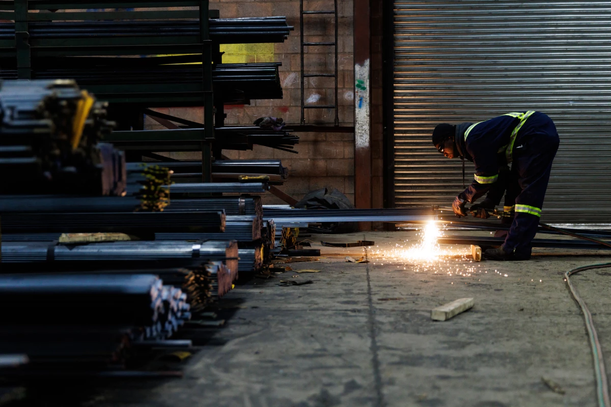 A worker cuts a piece of steel for a customer at North York Iron, a steel supplier in Toronto, Ontario, Canada, Feb. 11.