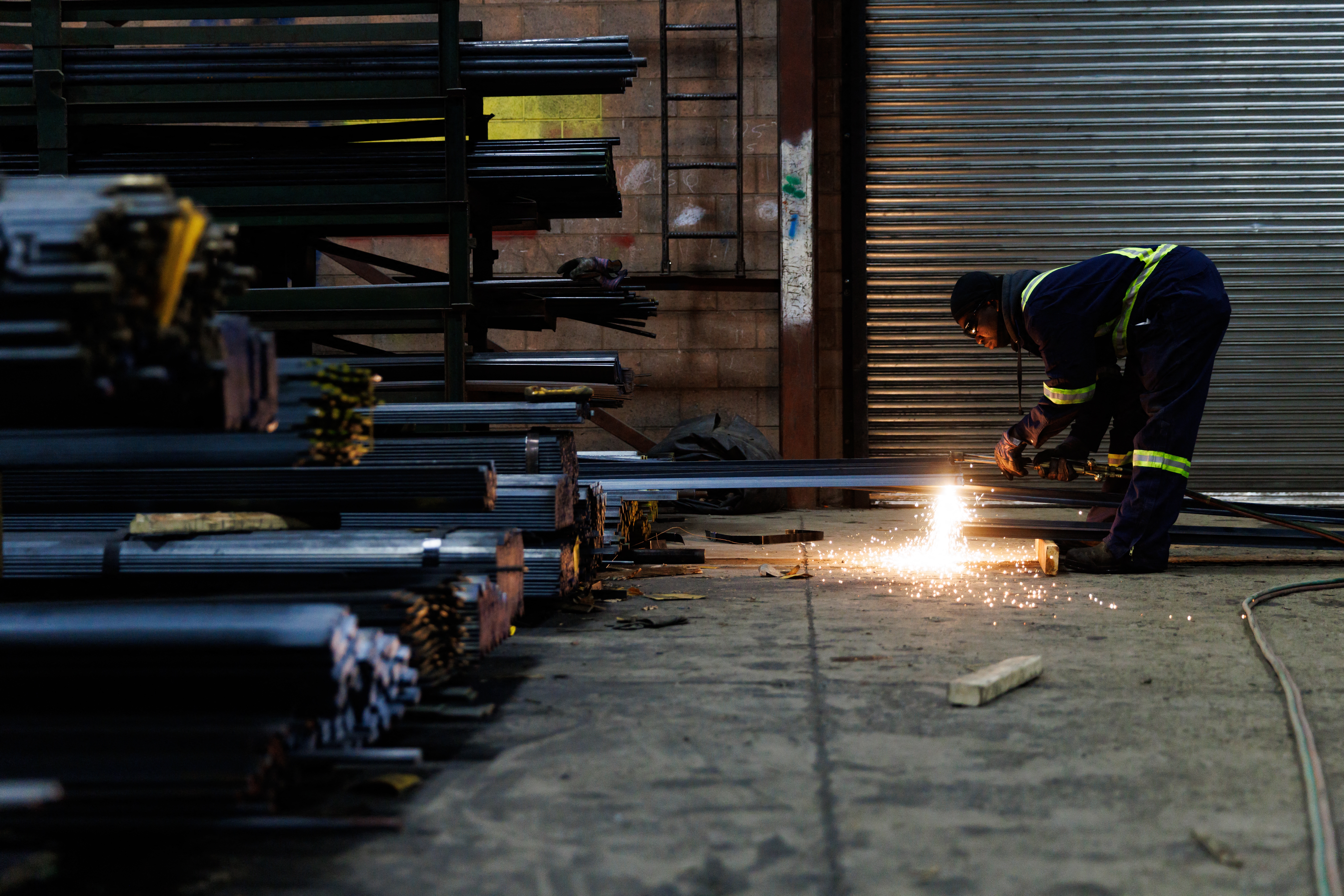 A worker cuts a piece of steel for a customer at North York Iron, a steel supplier in Toronto, Ontario, Canada, Feb. 11.