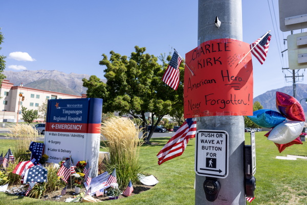 Flags and a sign honor Charlie Kirk at a memorial set up outside of Timpanogos Regional Hospital in Orem, Utah, on September 11, 2025.