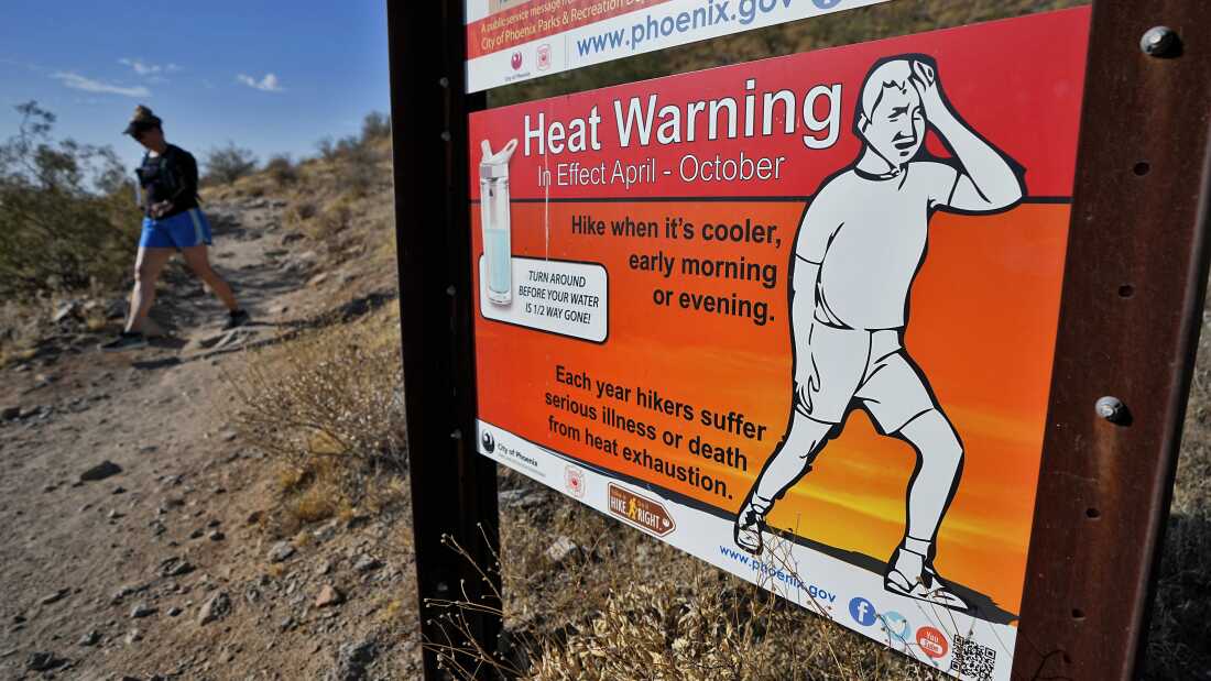 A hiker finishes her hike early to beat high temperatures on July 10, 2023, in Phoenix. 