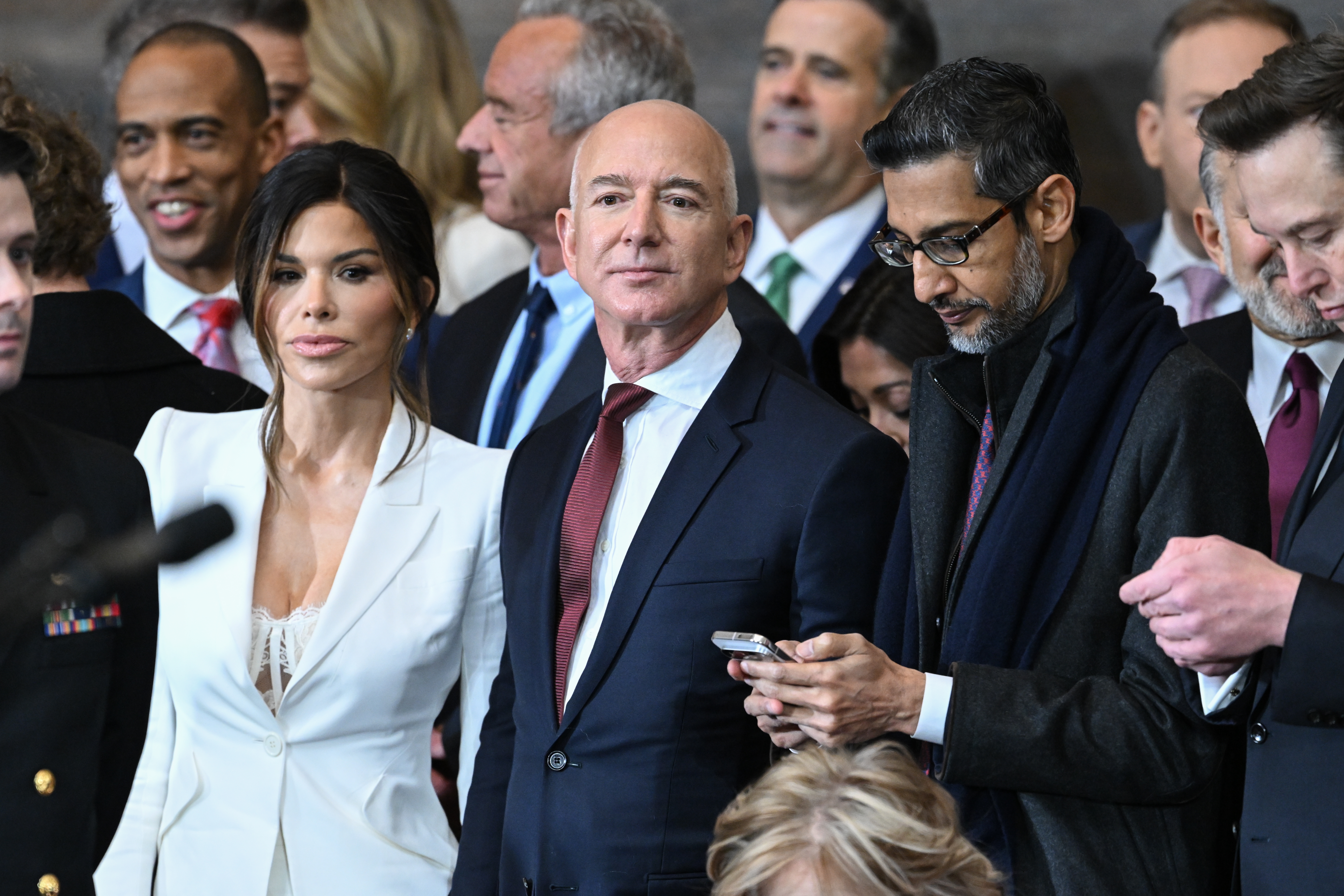 <!-- raw HTML omitted -->Washington Post <!-- raw HTML omitted -->owner Jeff Bezos, center, shown at the inauguration ceremony of President Trump at the U.S. Capitol in January.