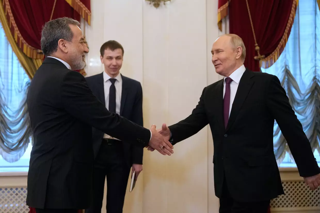 Russian President Vladimir Putin (right) shakes hands with Iranian Foreign Minister Abbas Araghchi during their meeting at the Boris Yeltsin Presidential Library in St. Petersburg, Russia, on Monday.