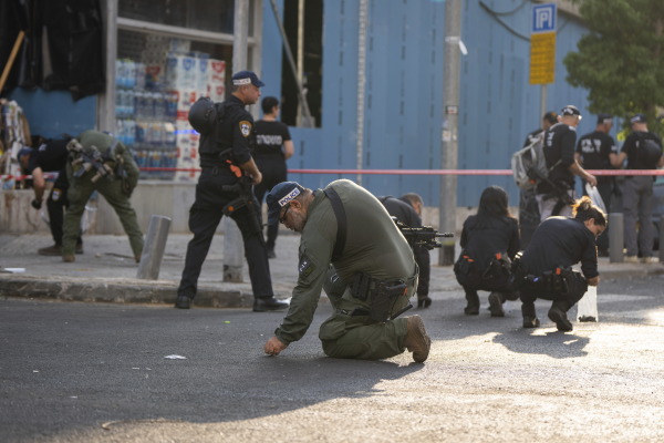 Israeli police investigate the scene of an explosive drone attack in Tel Aviv on Friday. Yemen's Houthi militia claimed responsibility for the attack, which killed one man and injured at least 10 civilians.
