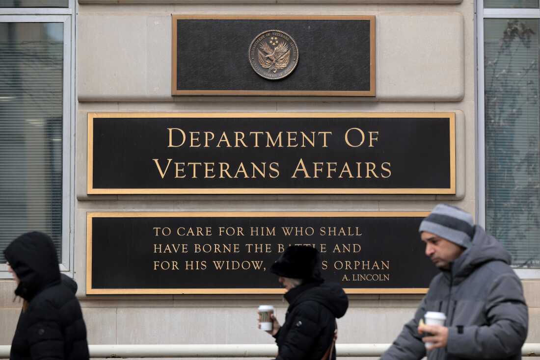 The Department of Veterans Affairs headquarters plaque is shown; beneath it is a plaque with a quote from Abraham Lincoln, "To care for him who shall have borne the battle and for his widow and his orphan."