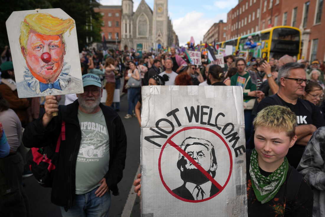 Protesters show placards during a demonstration against the visit of U.S. President Donald Trump in Dublin, Saturday, Sept. 12, 2026.
