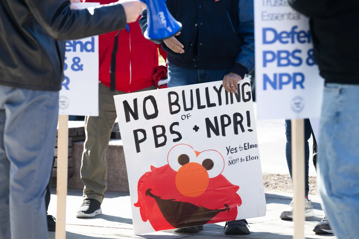A poster at a March 26 rally to protect funding for U.S. public broadcasters, PBS and NPR outside the NPR headquarters in Washington, D.C.