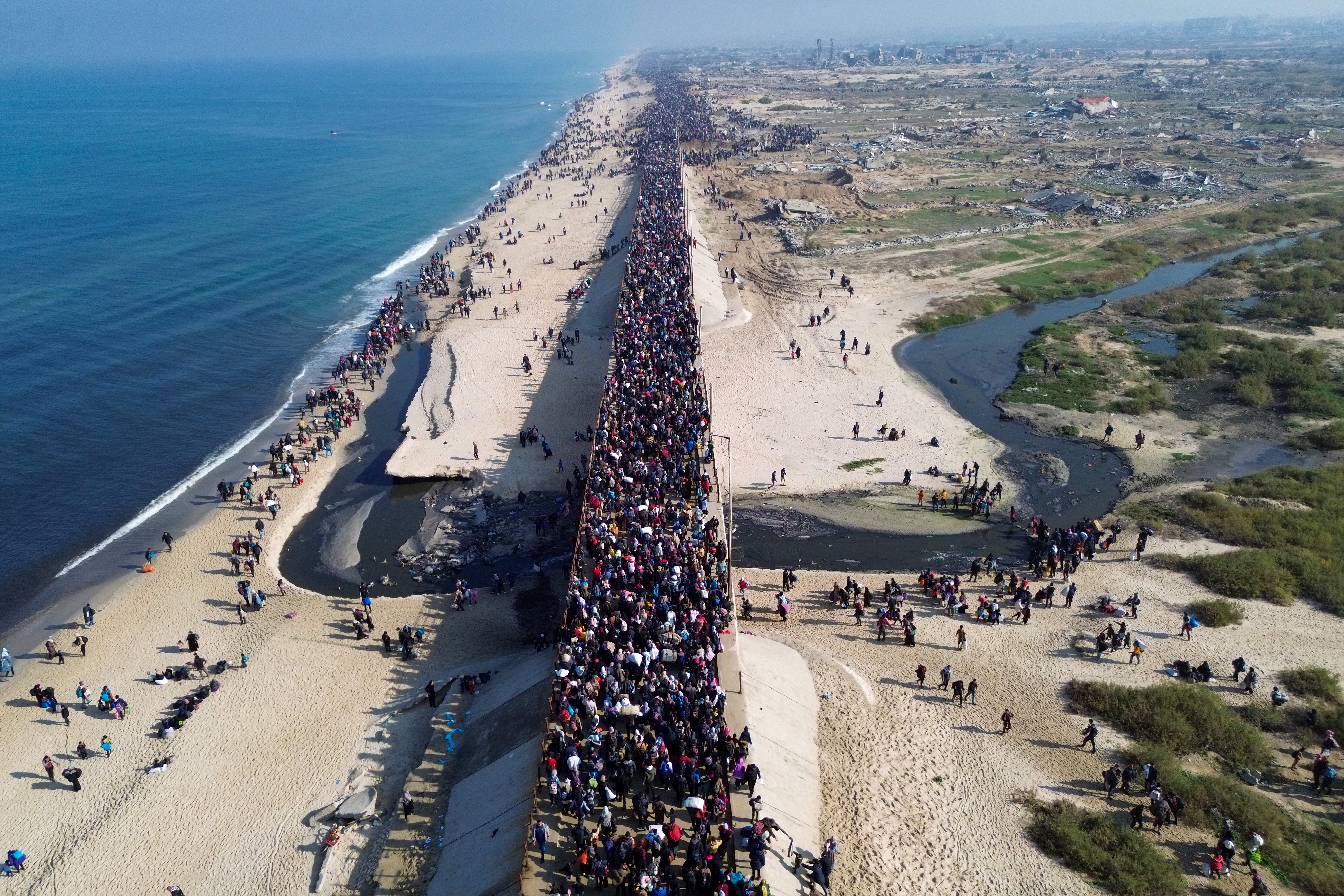 This aerial photo shows displaced Gazans walking toward Gaza City on Jan. 27, 2025, after crossing the Netzarim corridor from the southern Gaza Strip.