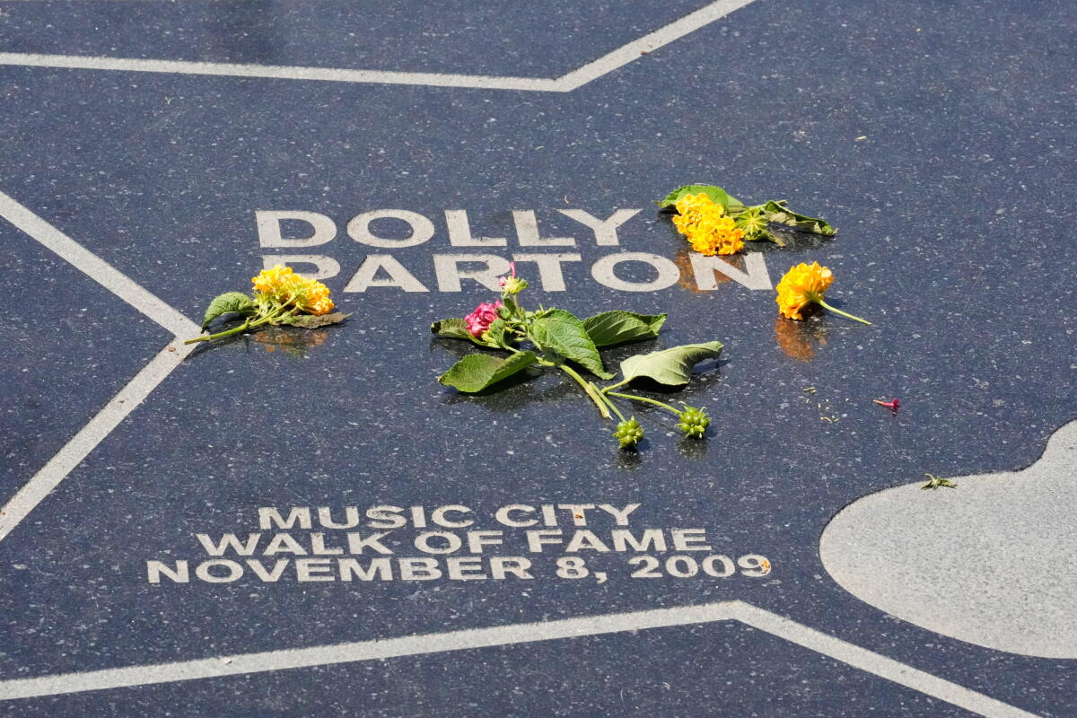 Flowers are placed on Dolly Parton's star at Walk of Fame Park on Tuesday, Aug. 25, 2026, in Nashville.
