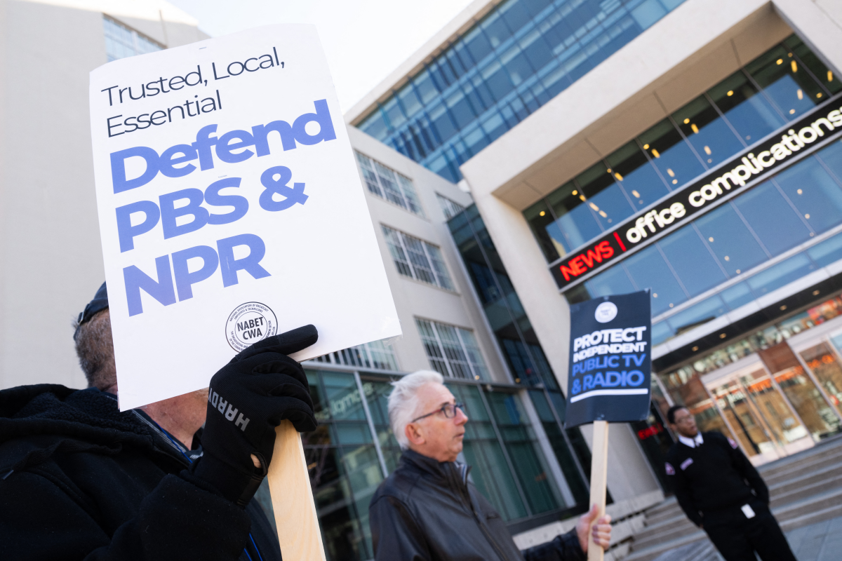 People rally for Congress to protect funding for public broadcasters outside NPR's Washington, D.C. headquarters in March. Congress voted in July to claw back over $1 billion in federal funding.