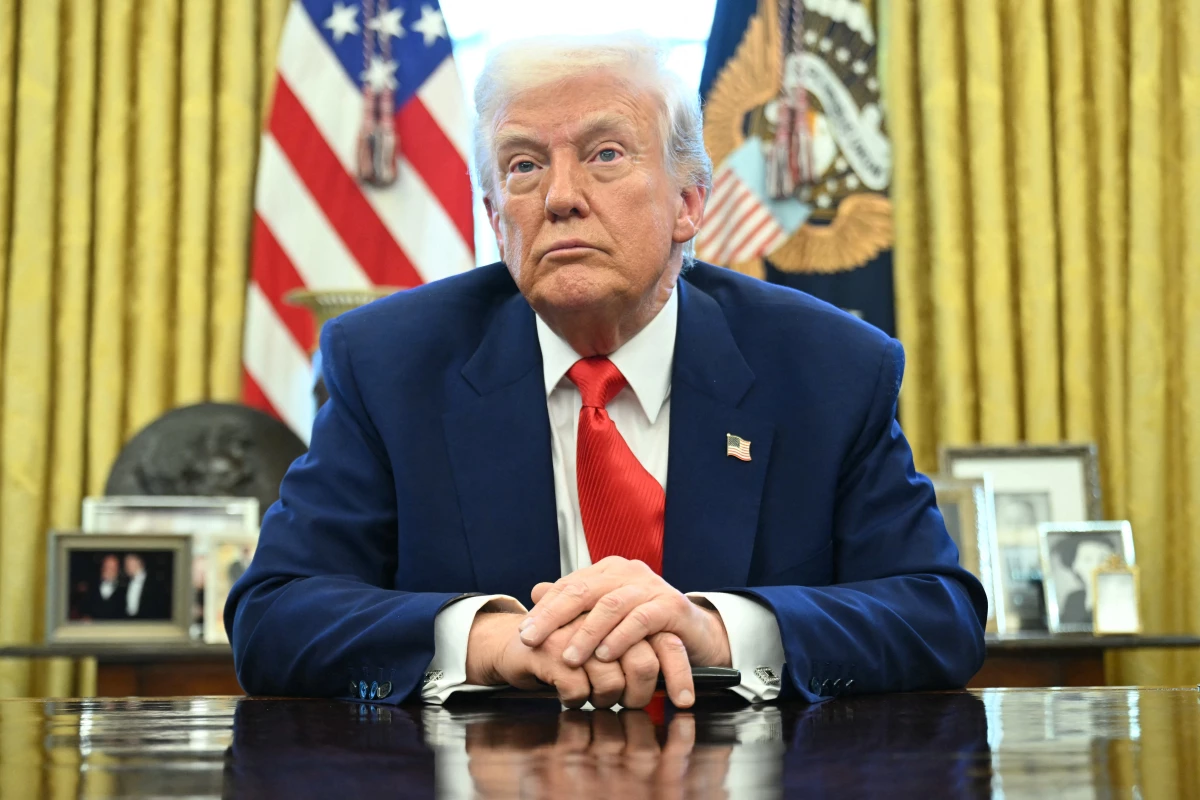 President Trump looks on after signing an executive order in the Oval Office of the White House on April 9, 2025 in Washington, DC.