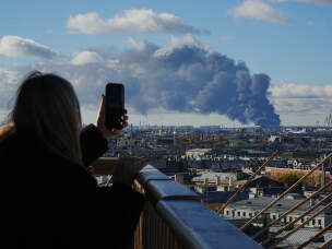 Smoke billows into the sky following Ukrainian drone strikes on an industrial zone in St. Petersburg, Russia, on Sunday, Oct. 18, 2026.