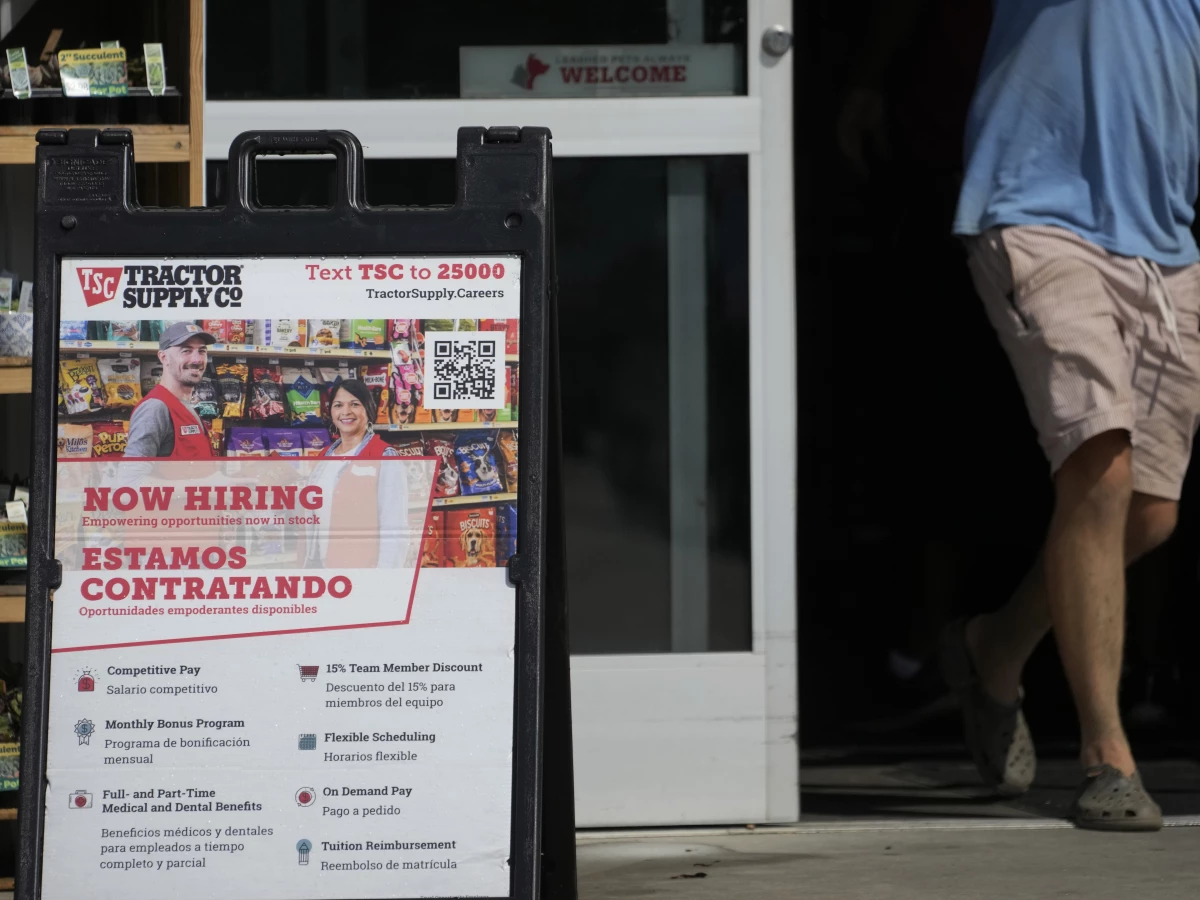 A sign in English and Spanish advertises jobs at a Tractor Supply store in Richland, Miss., in 2023.
