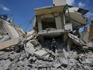 Hanan Qubaisi on Wednesday inspects her house destroyed in previous Israeli airstrikes in the town of Nabatiyeh, southern Lebanon, amid a fragile ceasefire between Israel and Hezbollah.