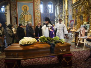 A priest prays over Kuvshynova's coffin during a funeral service at St. Michael's Cathedral in Kyiv on March 20, 2022.