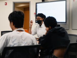 Netia McCray speaks with her students at the Museum of Science.