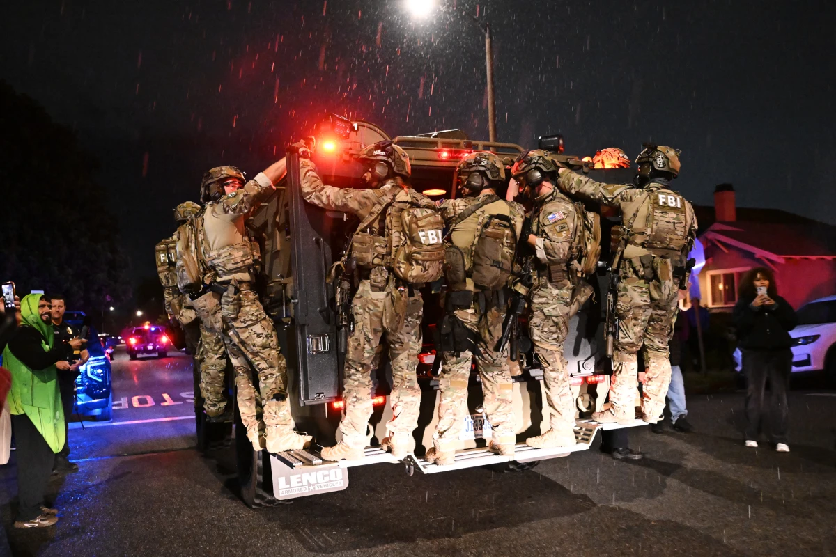 FBI officers leave the scene after responding to an address connected to Cole Tomas Allen, the shooting suspect at the White House Correspondents Dinner on Sunday in Torrance, Calif.